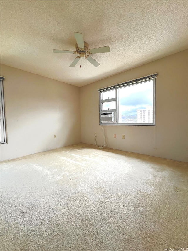 3009 Ala Makahala Pl Unit 1815, Honolulu, HI 96818 - spare room with carpet, a ceiling fan, a textured ceiling, and cooling unit