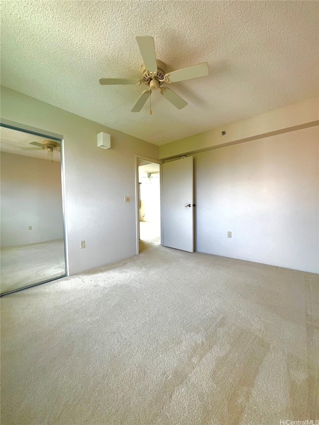 3009 Ala Makahala Pl Unit 1815, Honolulu, HI 96818 - unfurnished bedroom featuring carpet floors, ceiling fan, and a textured ceiling