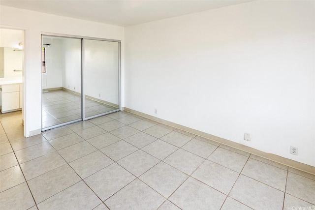 91-1199 Mikohu St Unit 39D, Ewa Beach, HI 96706 - unfurnished bedroom featuring a closet, light tile patterned flooring, and baseboards