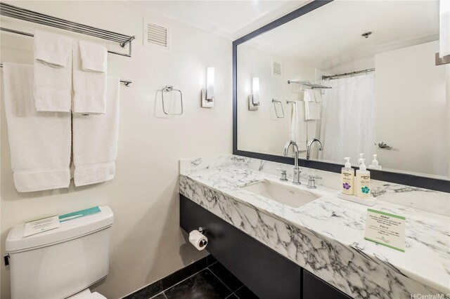 410 Atkinson Dr Unit 2418, Honolulu, HI 96814 - full bath with vanity, toilet, baseboards, and tile patterned floors