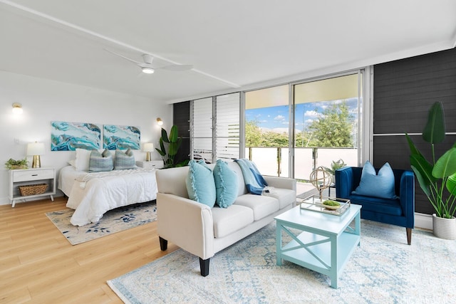 53-549 Kamehameha Hwy Unit 402, Hauula, HI 96717 - bedroom with wood finished floors, floor to ceiling windows, and a ceiling fan