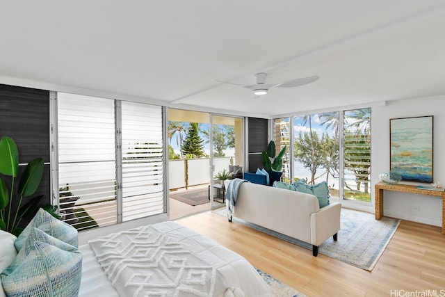 53-549 Kamehameha Hwy Unit 402, Hauula, HI 96717 - living area featuring expansive windows, wood finished floors, and ceiling fan
