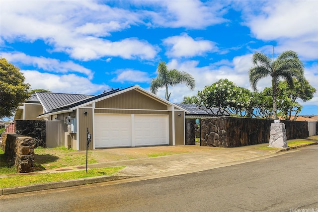 98-1027 Palula Way, Aiea, HI 96701 - view of front facade with an attached garage, driveway, solar panels, a metal roof, and a standing seam roof
