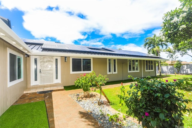 98-1027 Palula Way, Aiea, HI 96701 - back of property with solar panels, a metal roof, a lawn, and a standing seam roof