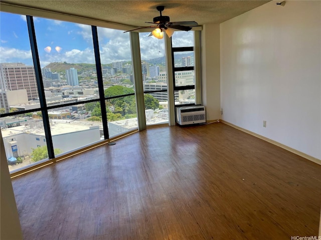 930 Kaheka St Unit 1703, Honolulu, HI 96814 - empty room featuring expansive windows, a view of city, wood finished floors, and ceiling fan