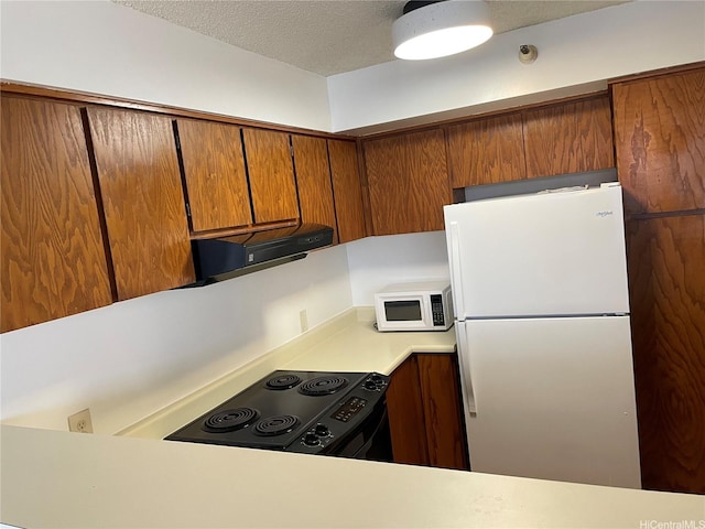 930 Kaheka St Unit 1703, Honolulu, HI 96814 - kitchen with white appliances, light countertops, brown cabinets, a textured ceiling, and extractor fan