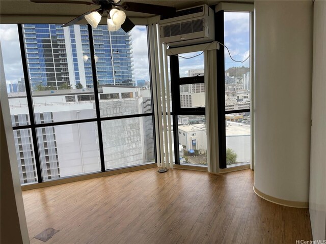 930 Kaheka St Unit 1703, Honolulu, HI 96814 - empty room with a view of city, plenty of natural light, a ceiling fan, wood finished floors, and expansive windows