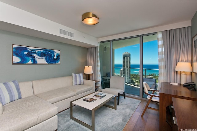 2139 Kuhio Ave Unit D2606, Honolulu, HI 96815 - living room with expansive windows, a water view, and wood finished floors