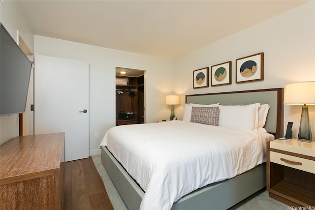 2139 Kuhio Ave Unit D2606, Honolulu, HI 96815 - bedroom featuring wood finished floors, a closet, and a spacious closet
