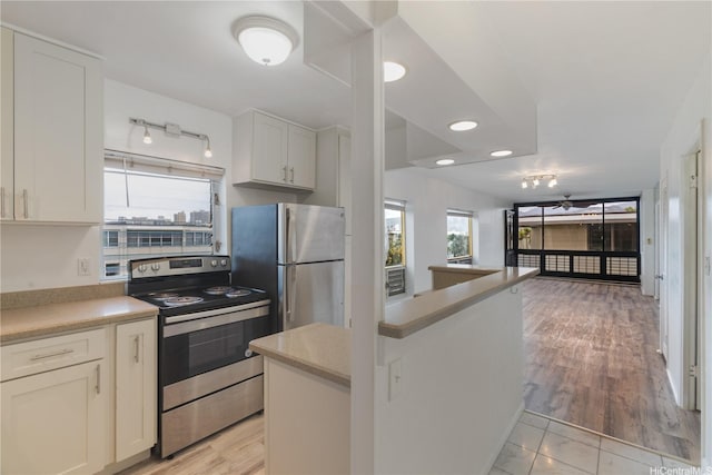 3071 Pualei Cir Unit 201, Honolulu, HI 96815 - kitchen featuring stainless steel appliances, light countertops, white cabinetry, open floor plan, and recessed lighting
