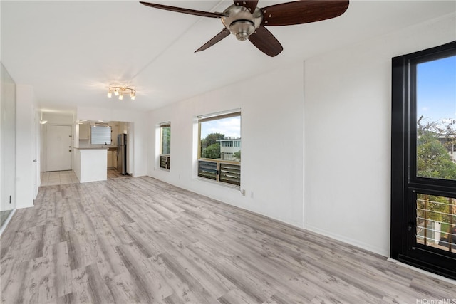 3071 Pualei Cir Unit 201, Honolulu, HI 96815 - unfurnished living room featuring healthy amount of natural light and light wood finished floors