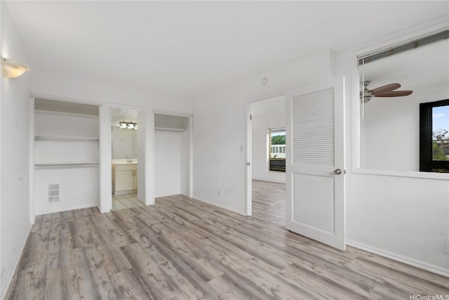 3071 Pualei Cir Unit 201, Honolulu, HI 96815 - unfurnished bedroom with wood finished floors, a sink, and connected bathroom