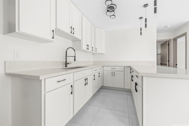 87-1474 Akowai Rd, Waianae, HI 96792 - kitchen with white cabinets, a peninsula, and light stone counters