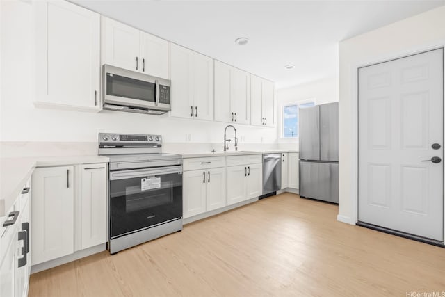 87-1474 Akowai Rd, Waianae, HI 96792 - kitchen featuring stainless steel appliances, white cabinetry, and light wood-style flooring