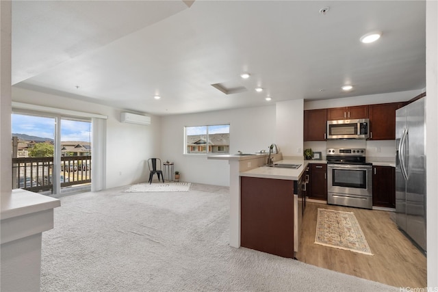 91-1081 Iwikuamoo St Unit 1202, Ewa Beach, HI 96706 - kitchen with appliances with stainless steel finishes, a wall unit AC, open floor plan, light countertops, and recessed lighting