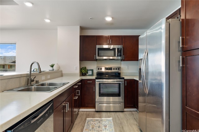 91-1081 Iwikuamoo St Unit 1202, Ewa Beach, HI 96706 - kitchen with stainless steel appliances, light wood-style flooring, light countertops, recessed lighting, and a peninsula