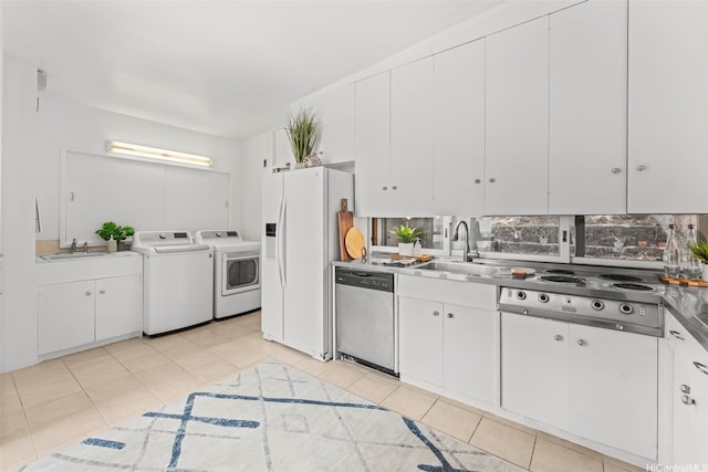 210 Hao St, Honolulu, HI 96821 - kitchen with stainless steel dishwasher, washing machine and dryer, stovetop, white refrigerator with ice dispenser, and white cabinetry