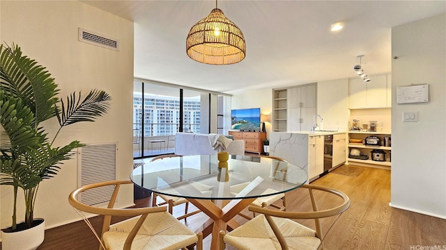 1910 Ala Moana Blvd Unit 32E, Honolulu, HI 96815 - dining area featuring light wood-style flooring and a wall of windows