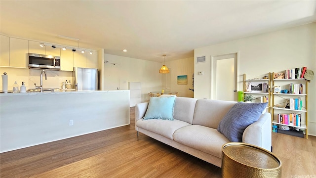 1910 Ala Moana Blvd Unit 32E, Honolulu, HI 96815 - living room featuring light wood finished floors