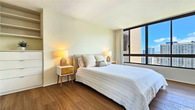 1910 Ala Moana Blvd Unit 32E, Honolulu, HI 96815 - bedroom featuring a city view and dark wood finished floors