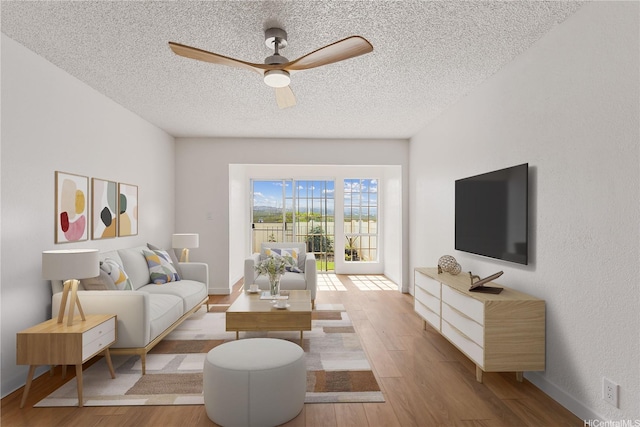 94-100 Huki Pl Unit S106, Waipahu, HI 96797 - living area featuring ceiling fan, a textured ceiling, wood finished floors, and baseboards