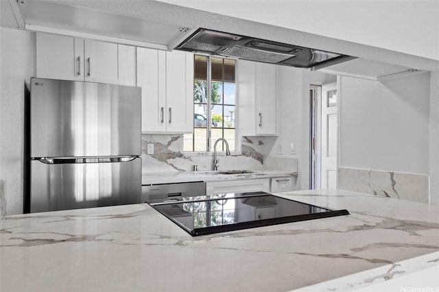 94-100 Huki Pl Unit S106, Waipahu, HI 96797 - kitchen featuring freestanding refrigerator, a sink, white cabinets, tasteful backsplash, and light stone counters