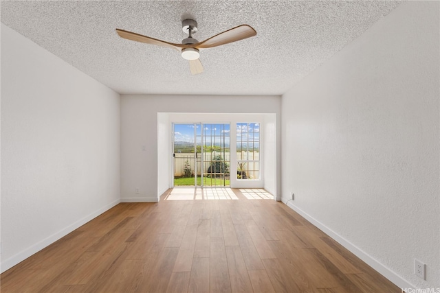 94-100 Huki Pl Unit S106, Waipahu, HI 96797 - empty room featuring wood finished floors, a ceiling fan, a textured ceiling, and baseboards