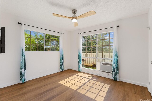 94-100 Huki Pl Unit S106, Waipahu, HI 96797 - empty room with ceiling fan, wood finished floors, baseboards, a textured ceiling, and cooling unit