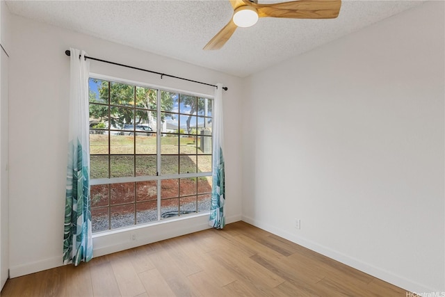 94-100 Huki Pl Unit S106, Waipahu, HI 96797 - empty room featuring a textured ceiling, wood finished floors, baseboards, and a ceiling fan