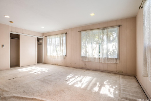 1425 Monte Cooke Pl, Honolulu, HI 96817 - unfurnished bedroom featuring multiple windows, carpet flooring, recessed lighting, wooden walls, and multiple closets