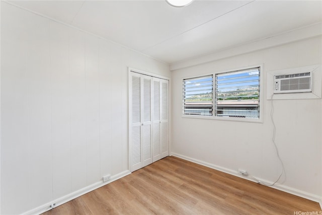 92-721 Anipeahi St, Kapolei, HI 96707 - unfurnished bedroom with light wood-type flooring, a wall mounted AC, and a closet