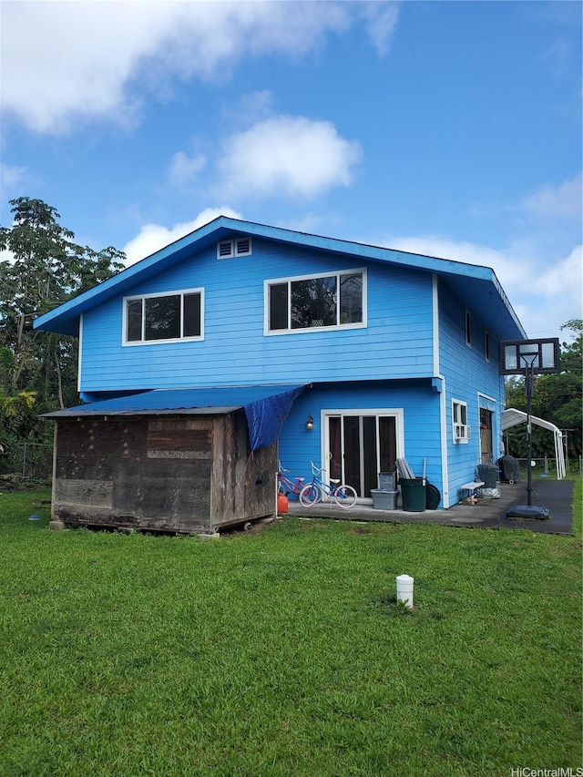 14-808 Crystal Cir, Pahoa, HI 96778 - back of house featuring a lawn and a patio