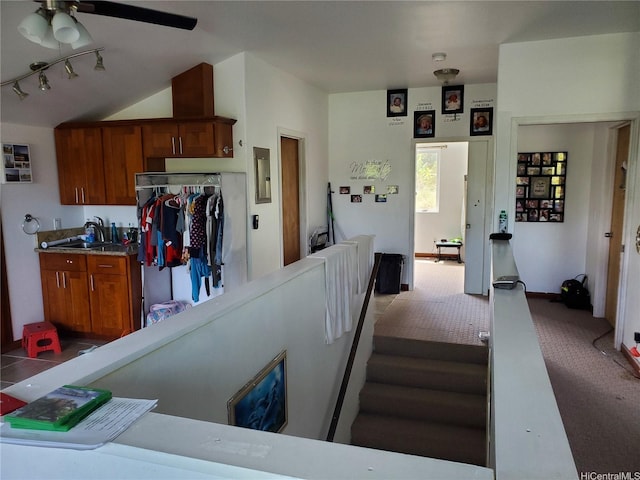 14-808 Crystal Cir, Pahoa, HI 96778 - kitchen with fridge, dark carpet, a sink, a ceiling fan, and brown cabinets