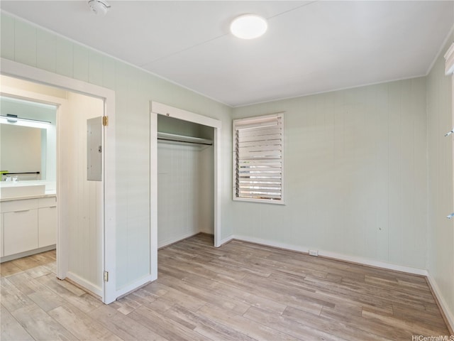 3622 Maunalei Ave, Honolulu, HI 96816 - unfurnished bedroom with electric panel, light wood-type flooring, a closet, baseboards, and ensuite bath