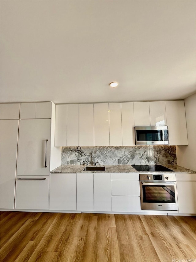 987 Queen St Unit 2403, Honolulu, HI 96814 - kitchen with appliances with stainless steel finishes, white cabinetry, modern cabinets, and backsplash