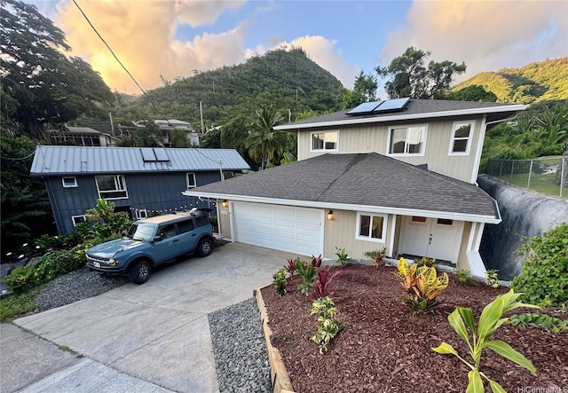 2318 Waiomao Rd Unit 4, Honolulu, HI 96816 - view of front of property featuring driveway, solar panels, a shingled roof, and an attached garage