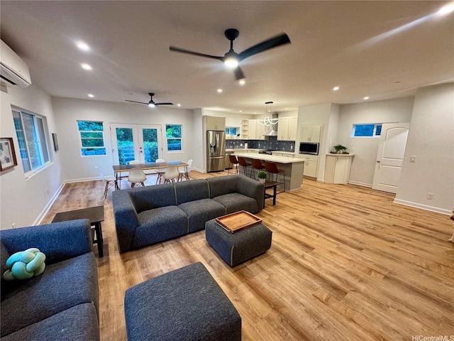 2318 Waiomao Rd Unit 4, Honolulu, HI 96816 - living room with a ceiling fan, recessed lighting, light wood-style floors, a wall mounted air conditioner, and baseboards