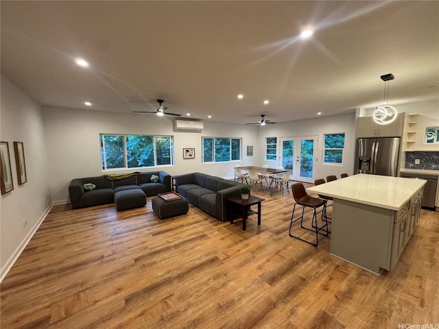2318 Waiomao Rd Unit 4, Honolulu, HI 96816 - living room with a wall mounted AC, recessed lighting, light wood-type flooring, baseboards, and ceiling fan