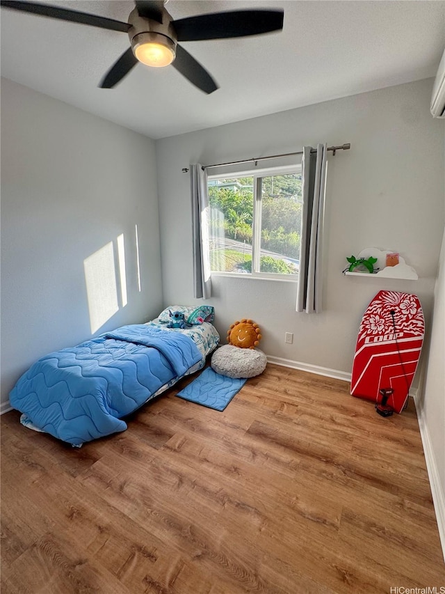 2318 Waiomao Rd Unit 4, Honolulu, HI 96816 - bedroom with wood finished floors, baseboards, ceiling fan, and a wall mounted air conditioner