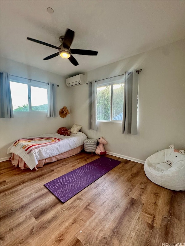 2318 Waiomao Rd Unit 4, Honolulu, HI 96816 - bedroom featuring a wall unit AC, wood finished floors, multiple windows, and baseboards