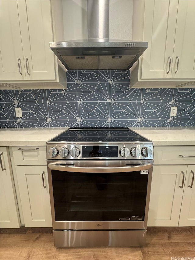2318 Waiomao Rd Unit 4, Honolulu, HI 96816 - kitchen featuring stainless steel range with electric cooktop, wall chimney range hood, light countertops, and backsplash