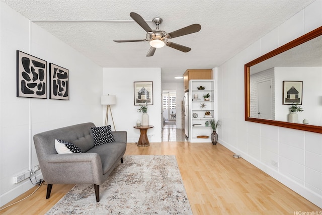 425 Ena Rd Unit Ph3B, Honolulu, HI 96815 - living area featuring light wood-style flooring, ceiling fan, a textured ceiling, and baseboards