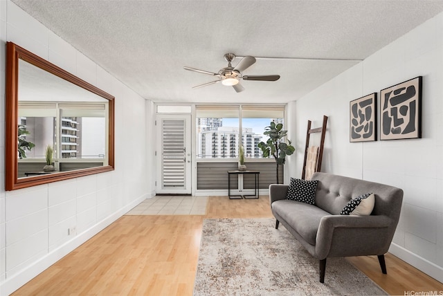 425 Ena Rd Unit Ph3B, Honolulu, HI 96815 - living room with wood finished floors, a ceiling fan, and a textured ceiling