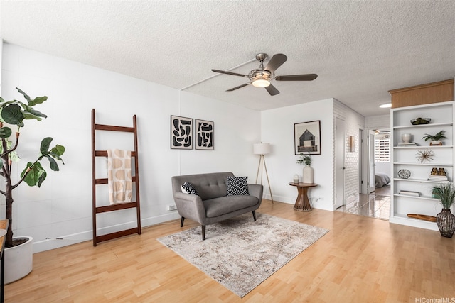 425 Ena Rd Unit Ph3B, Honolulu, HI 96815 - living area with light wood-type flooring, a ceiling fan, and a textured ceiling