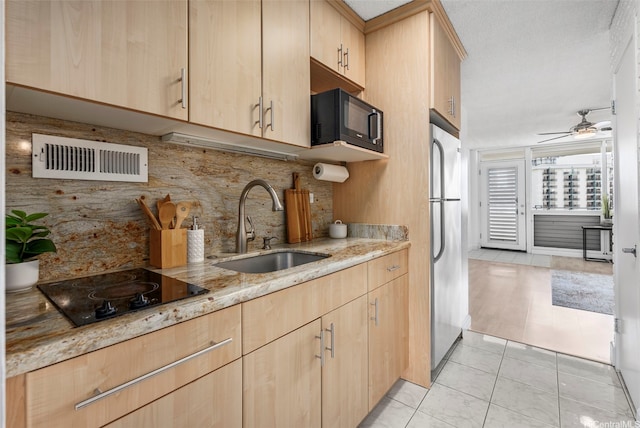425 Ena Rd Unit Ph3B, Honolulu, HI 96815 - kitchen featuring light brown cabinetry, black appliances, a sink, light stone countertops, and backsplash