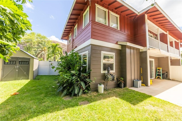 87-107 Kulaaupuni St Unit 2, Waianae, HI 96792 - rear view of property with board and batten siding, a shed, and a patio area