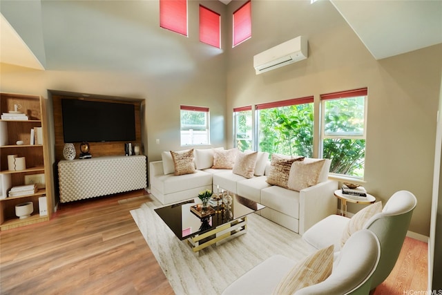 87-107 Kulaaupuni St Unit 2, Waianae, HI 96792 - living room featuring a wall mounted air conditioner, a high ceiling, and wood finished floors