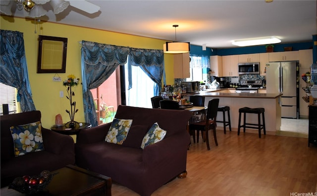 94-1059 Pouhana Way Unit 3, Waipahu, HI 96797 - living area featuring light wood-style floors and ceiling fan