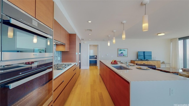 1108 Auahi St Unit 3201, Honolulu, HI 96814 - kitchen with appliances with stainless steel finishes, open floor plan, light wood finished floors, modern cabinets, and a spacious island