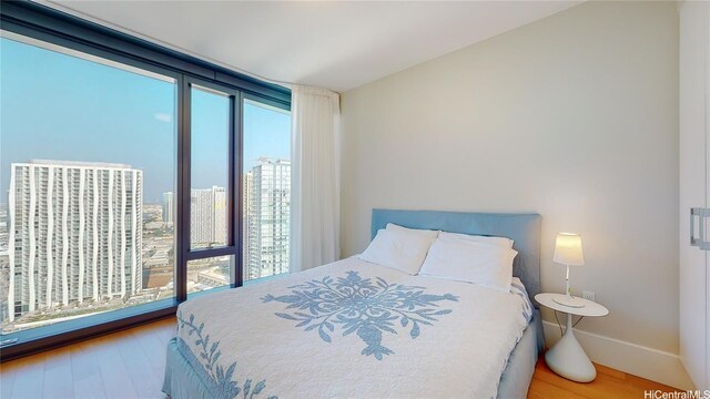 1108 Auahi St Unit 3201, Honolulu, HI 96814 - bedroom featuring wood finished floors and a view of city